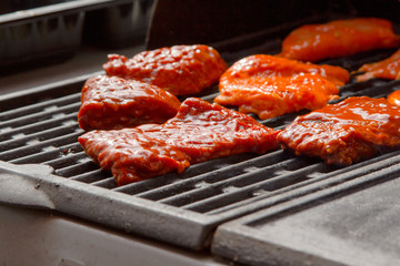 Grilling meat on gas grill at sunny day