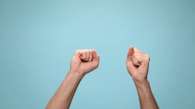 two hands rolling into fists that hit one another, pointing forward and gesturing a beat up sign on blue background