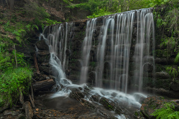 Fototapeta na wymiar Waterfall on Divoky creek near Kouty nad Desnou village in summer day