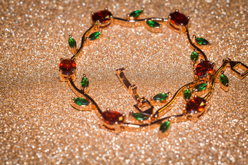 Bracelet with red and green zircons