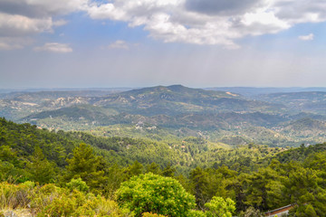 Alpine scenery in the mountain system of Troodos, Cyprus.  A view from the heights of the mountains and hills covered with pine trees and other trees.