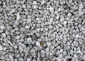 Slag in the form of small gray stones, top view. Waste rock during iron ore mining.