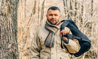 Obraz premium Portrait of a handsome young man with a beard hanging out outdoors.