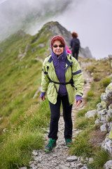 Woman hiking on a trail in the mountains