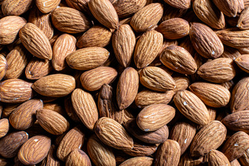 background of raw shelled almonds fully filled top view close up