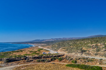 View of the Mediterranean sea panorama.  Stone-sandy landscape with rare vegetation and the sea coast.