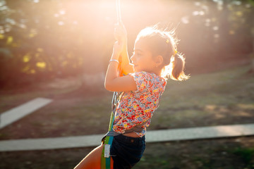 Happy kid enjoying activity in a climbing adventure park.