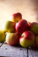 Composition of village red apples on a wooden table