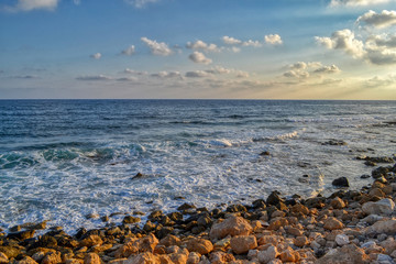 Coastal cliffs in the harbor of Paphos, Cyprus.  Beautiful view of the Mediterranean Sea at sunset.