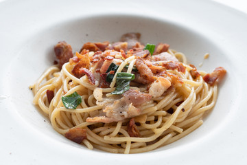 spaghetti with basil pesto and bacon - Italian food - closed up