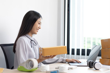 Young Asian woman taking a selfie to verify her online shipping identity.