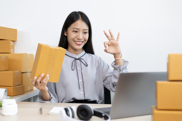 Young Asian woman taking a selfie to verify her online shipping identity.