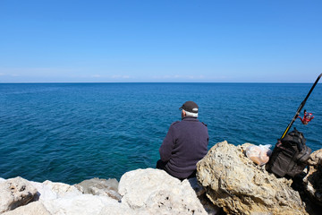 Fototapeta na wymiar Fisherman by the sea