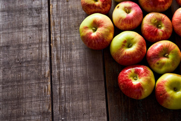 Composition of village red apples on a wooden table. With copy space.