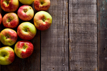 Composition of village red apples on a wooden table. With copy space.