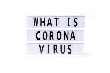 What is corona virus. Text on a vintage lightbox display placed on a white table on a light background. 
