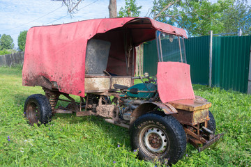 A self-made all-terrain vehicle with a trailer, created on the basis of a motorcycle of the Ural heavy class and from spare parts from motor vehicles.