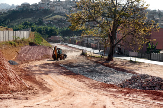 access road under construction, machines and vehicles do the heavy lifting