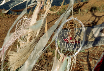 Fototapeta na wymiar dream catchers with ribbons and feathers sway in the wind