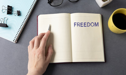 Text financial freedom on note paper on office table