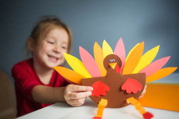 paper craft for kids. DIY Turkey made for thanksgiving day. create art for children. girl playing...
