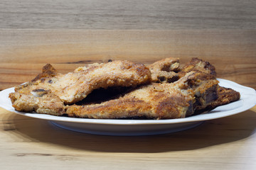 breaded chops or cutlets on a white plate