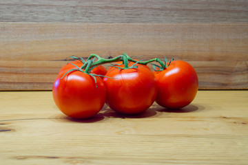 fresh tomatoes on a wooden table