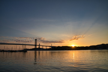 Fototapeta na wymiar Bridge, tranquil ocean and dramatic sunset