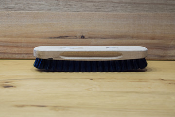 brush for leather shoes with wooden background