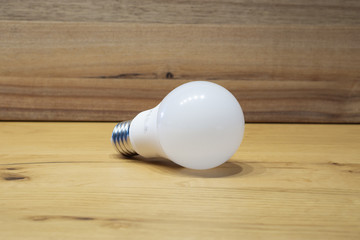 white light bulb with wooden background