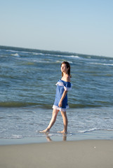 Fototapeta na wymiar Woman on the Black Sea coast. Model without makeup posing on the seashore. Summer vacation concept