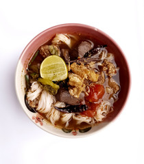 Spicy rice noodle with pork (Khanom Jeen Nam Ngiao) isolated on white background. The recommended Northern Thai dish.