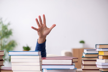 Young male student preparing for exams at home