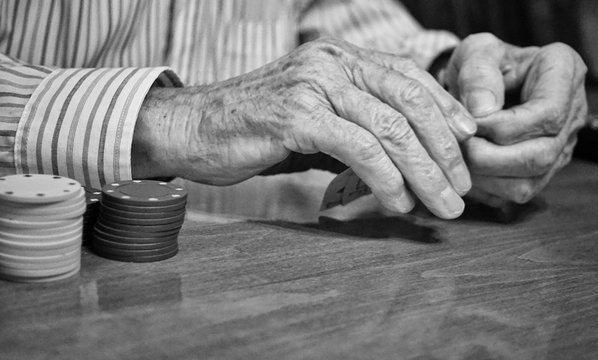 Black And White Close Up Of The Hands Of An Old Man Playing Poker