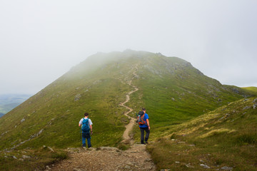 Climbers on a Scottish Munro Mountain in the mist 