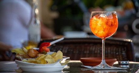 Close up of a glass of Spritz, the typical northern italy drink or aperitif, made with sparkling...
