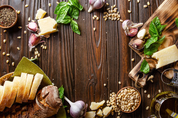 Flat lay view at food background of genovese pesto sauce ingredients on wooden kitchen table with copy-space