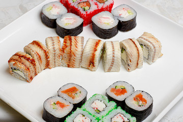 set of different types of sushi on a white plate