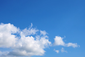 Naklejka na ściany i meble Blue sky and white air clouds. Copyspace background or wallpaper. Right place for text. Summer atmosphere, clear skies. Backdrop for weather forecast