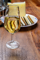 Spanish fino sherry wine from Andalusia and pieces of different sheep hard manchego cheeses made in La Mancha, Spain. Wine and cheese pairing