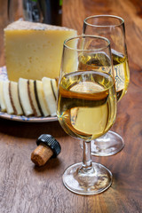 Spanish fino sherry wine from Andalusia and pieces of different sheep hard manchego cheeses made in La Mancha, Spain. Wine and cheese pairing