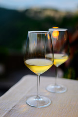 Two glasses of cold dry white wine served outdoor in cafe at night in Italy