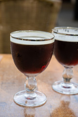 Glasses with cold dark strong Belgian beer served outdoor