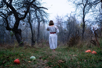 Woman walking barefoot in autumn foggy forest