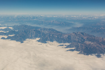 Fototapeta premium View of the mountain landscape from the plane in the afternoon