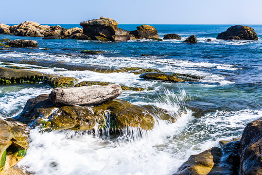 The beautiful coastal reef and sea waves with blue sky in New Taipei, Taiwan