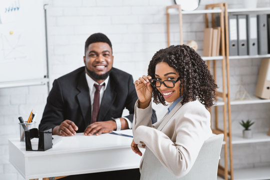 Joyful human resources manager and successful vacancy applicant on employment interview at office
