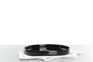 Empty plate and napkin on light table