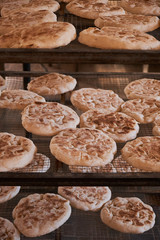 Fluffy flatbreads in bakery shelves.