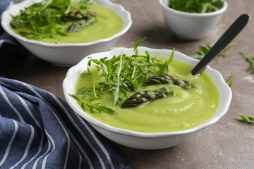 Delicious asparagus soup served on grey marble table